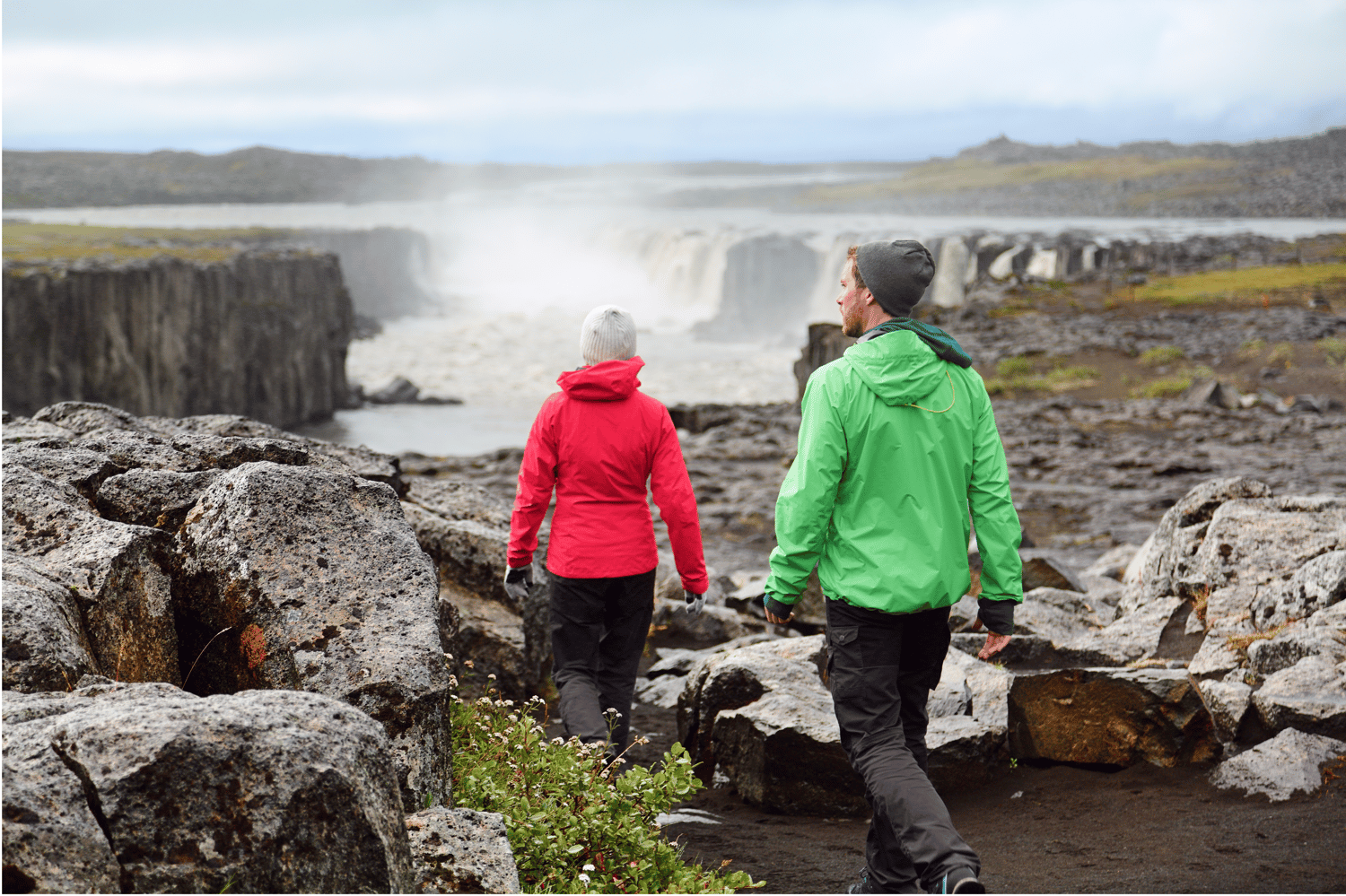 Models hiking near a waterfall